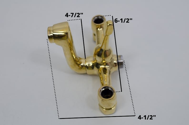 Wandmontierte Badewannenarmatur aus unlackiertem Messing mit Handbrause